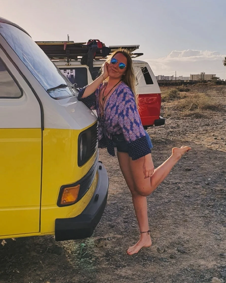 Klaudia in Tenerife posing with a yellow camper van