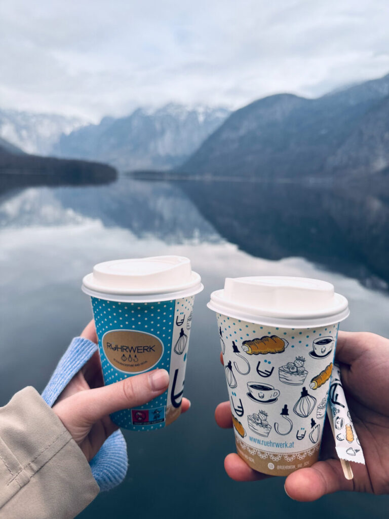 two coffee mugs with the lake in background